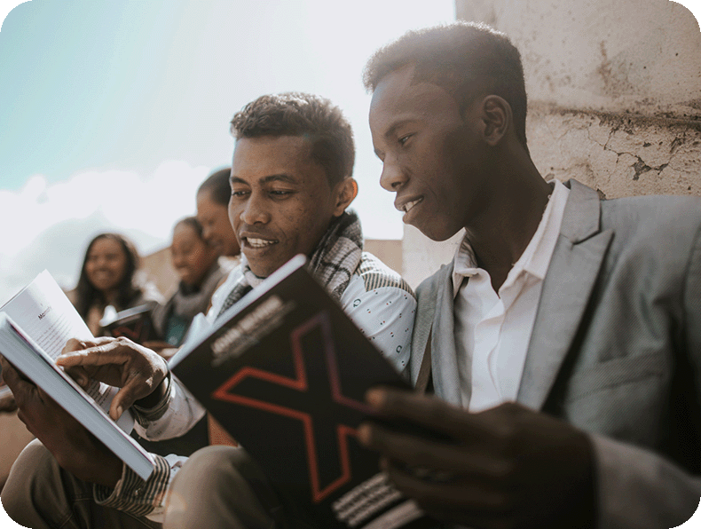 Photos showing people reading books created by Messenger International and translated around the world. Madagascar