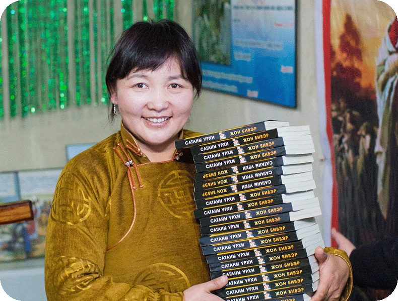 Photos showing people reading books created by Messenger International and translated around the world. Mongolia