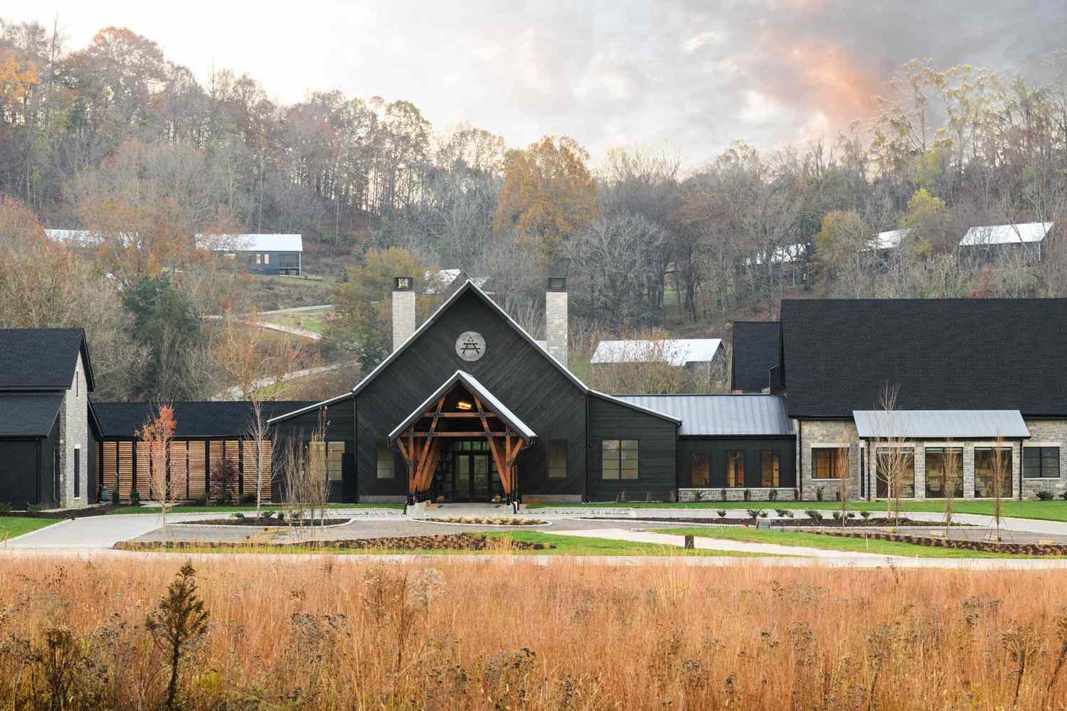 The main lodge at Southall, set against wooded hills in late autumn